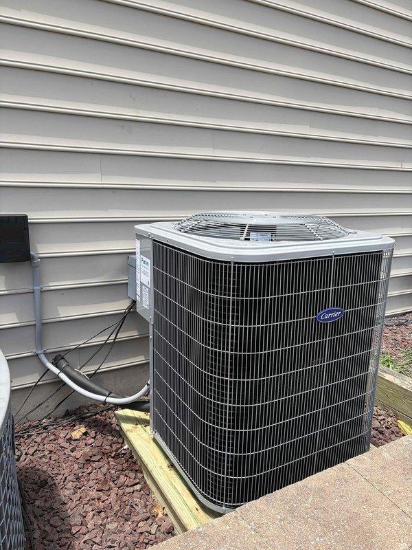 Removed and disposed of existing first-floor air conditioning condenser and evaporator coil. Installed new Carrier 26SCA542 3.5-ton 14.3 SEER outdoor unit on platform with CAAMP4221 evaporator coil connected to existing furnace. Flushed and pressure tested refrigerant lines to verify system integrity, then charged system to manufacturer specifications. Installed 1200 series non-WiFi thermostat to complete half-system replacement. All equipment tested and operational upon completion.