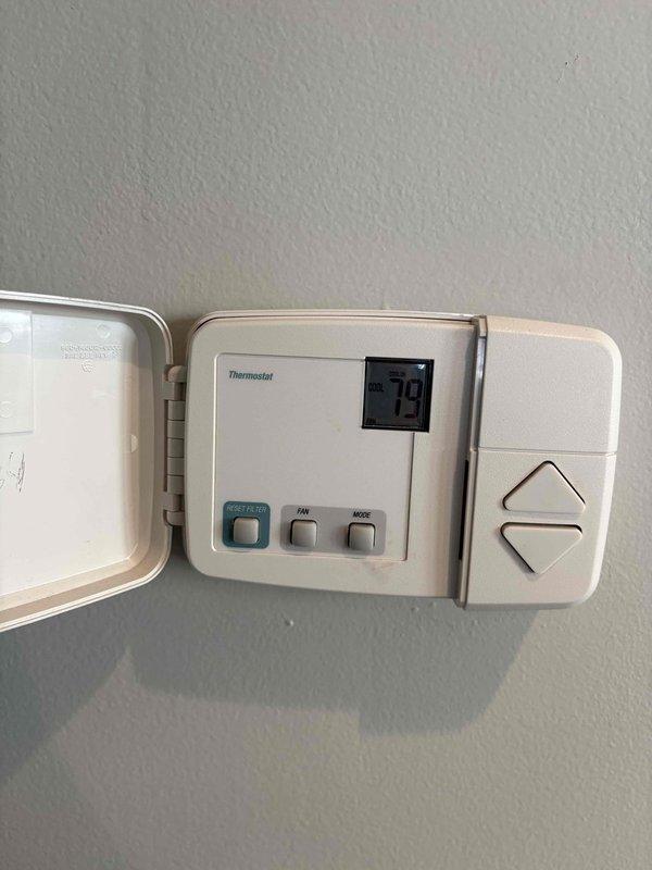 Responded to no cooling complaint. Upon arrival, found thermostat displaying error code -79, indicating a communication or sensor malfunction. Inspected wall-mounted thermostat and verified system settings. Documented equipment conditions with photos showing thermostat interface and attic access location for future reference. Advised customer of findings and discussed diagnostic results.
