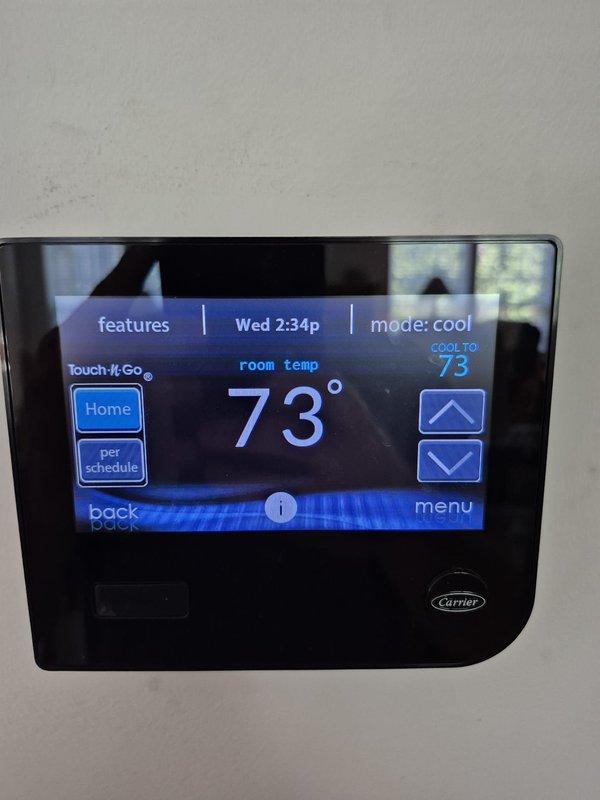 Completed routine cooling maintenance visit on two HVAC systems. Verified thermostat operation showing system cooling to setpoint of 73°F in cooling mode, and performed electrical diagnostics measuring amperage draw at 1.73 amps on air handler components to confirm proper system operation.