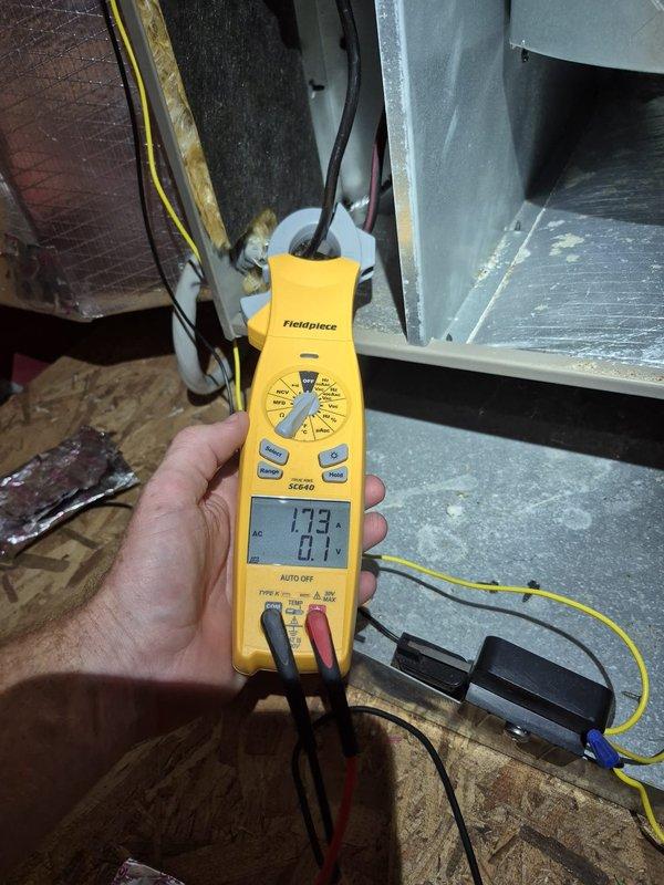 Completed routine cooling maintenance visit on two HVAC systems. Verified thermostat operation showing system cooling to setpoint of 73°F in cooling mode, and performed electrical diagnostics measuring amperage draw at 1.73 amps on air handler components to confirm proper system operation.