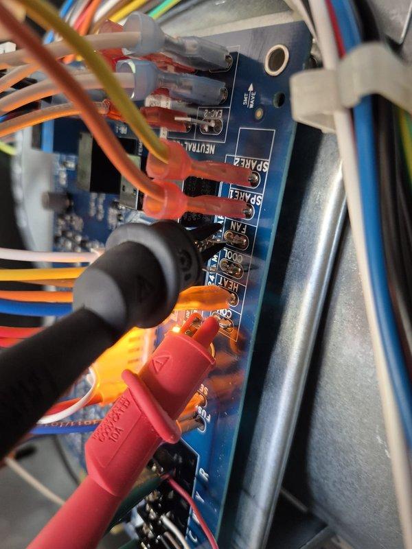 Responded to no cooling call with reported fan motor not operating. Upon arrival, performed electrical diagnostics on the air handler control board and terminal connections. Utilized multimeter to test voltage at various connection points, measuring 27.7 VAC at control terminals. Inspected wiring harness, terminal block connections, and control board components to identify cause of blower motor failure and restore cooling operation.
