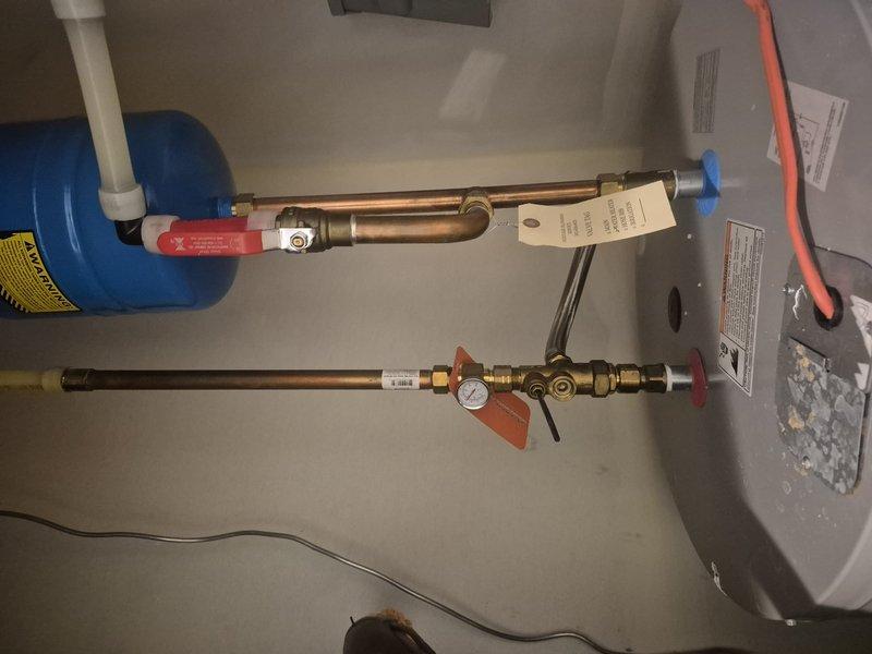 Provided comprehensive estimate for replacement of existing 80-gallon residential water heater. Assessed current installation including expansion tank, copper supply lines with brass fittings and shutoff valves, pressure relief components, and electrical connections. Evaluated utility room configuration and existing plumbing infrastructure to determine scope of work required for new unit installation, including proper venting, code-compliant connections, and integration with HVAC system in shared mechanical space.