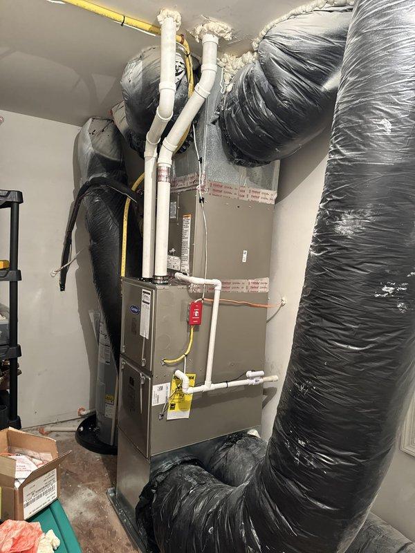 Completed full HVAC system replacement including removal and disposal of existing equipment. Installed Carrier 59TP6C080V17 96% AFUE gas furnace with two-stage burners and variable speed blower, Carrier 26SCA536A003 3-ton 15 SEER air conditioning unit, and Carrier CVAVA3617 evaporator coil. Fabricated and installed metal duct transitions to adapt new equipment to existing ductwork. Replaced outdoor electrical disconnect and whip while reusing existing electrical service, condensate drain lines, and refrigerant line set. Mounted outdoor condenser unit on pressure treated wood platform for proper equipment elevation and drainage. Converted furnace to LP fuel operation with installation of LP conversion kit. Installed Honeywell THX1200W5 WiFi programmable thermostat for enhanced system control and remote access capability. Performed complete system startup, tested all safety controls, verified proper airflow across evaporator coil, and confirmed two-stage heating operation. Measured and d