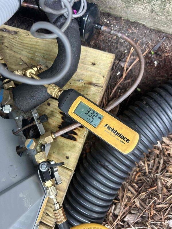Responded to emergency service call for two-year-old air conditioning unit with complete system failure. Upon arrival, diagnosed critically low refrigerant charge with system nearly flat. Connected manifold gauges to verify pressures and added refrigerant along with UV dye to restore cooling operation and enable future leak detection. Given the age of the equipment and severity of refrigerant loss, recommended follow-up pressure test to identify leak source, as the charge may not hold long-term without proper repair of underlying issue.