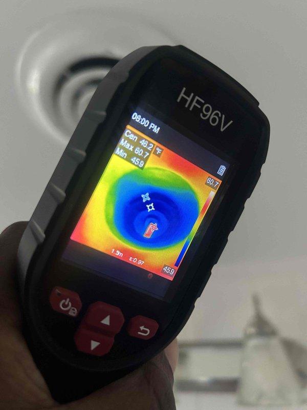Responded to emergency no-cooling call on five-year-old air conditioning system at rental property. Upon inspection, identified failed capacitor with significant corrosion on mounting cap and confirmed diagnosis using thermal imaging to verify lack of heat transfer at evaporator coil, which registered abnormally low temperatures (45-60°F range) indicating refrigerant flow issues caused by compressor not operating. Replaced defective capacitor, restored all electrical connections, and verified system returned to normal cooling operation.