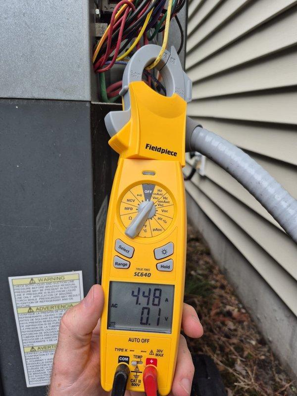 Completed routine cooling maintenance visit on residential HVAC system. Performed standard diagnostic checks including electrical measurements at outdoor unit, verified proper amperage draw of 448 amps, and confirmed thermostat operation showing 77°F setpoint with system scheduled to activate in 1 hour 15 minutes. All components operating within normal parameters and system found to be functioning properly with energy-saving mode enabled.
