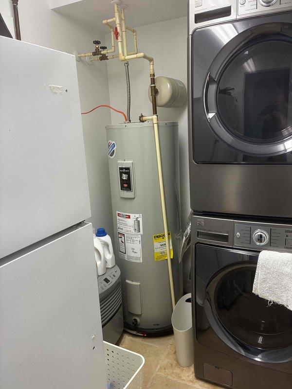 Responded to service call for low water pressure complaint. Upon inspection, evaluated residential water heater and associated plumbing connections in utility room. Assessed water heater installation, including inlet/outlet piping configuration, pressure relief valve, and copper supply lines. Documented existing water heater dimensions (20"W x 58"H) and clearance measurements for equipment accessibility. Identified plumbing system layout and photographed current installation for reference. Provided estimate for water heater replacement as requested by customer.