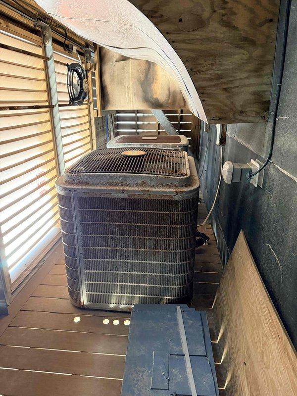 Responded to service call for non-operational main level HVAC system. Performed comprehensive assessment of outdoor condensing unit showing signs of age and wear, including discoloration and dirt accumulation on exterior surfaces. Evaluated indoor evaporator coil assembly in attic space, inspecting foil-wrapped coil unit, galvanized drain pan, and PVC condensate drainage system for proper operation and potential failure points. Documented equipment condition through photographic evidence to support replacement estimate for aging system components.