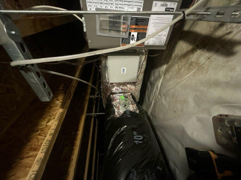 Completed full HVAC system replacement including removal and disposal of existing equipment. Installed MLKP1-030 2.5 ton heat pump outdoor unit on platform and CBK45UHVT-30 fan coil unit in attic space. Added ECB10 10KW electric heater with breakers for supplemental heating. Integrated system with existing zone board and damper controls, which remain outside warranty coverage. Flushed, pressure tested, and recharged refrigeration lines to manufacturer specifications. Installed two Honeywell S1200W WiFi thermostats for dual-zone temperature control. Verified proper airflow through ductwork connections and confirmed all electrical connections at junction boxes. System startup completed with all components operating within normal parameters. Customer enrolled in one-year equipment maintenance contract covering single system.