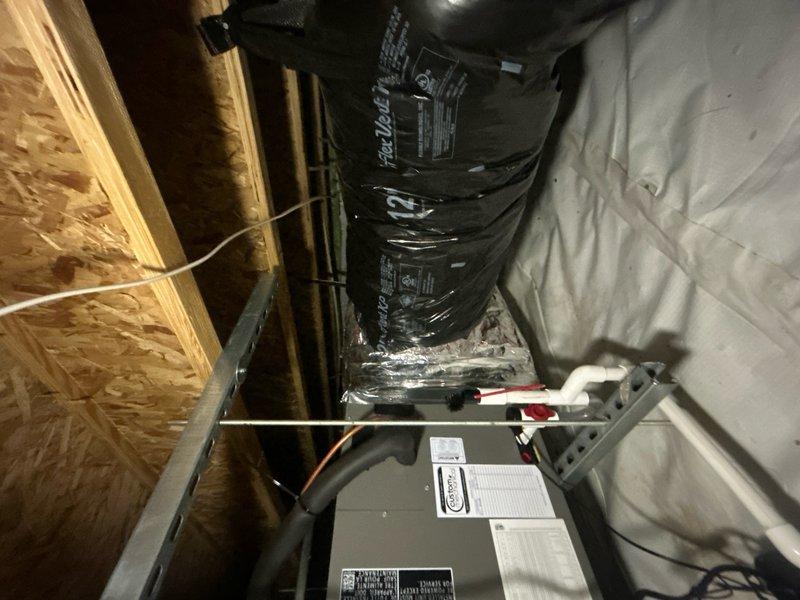 Completed full HVAC system replacement including removal and disposal of existing equipment. Installed MLKP1-030 2.5 ton heat pump outdoor unit on platform and CBK45UHVT-30 fan coil unit in attic space. Added ECB10 10KW electric heater with breakers for supplemental heating. Integrated system with existing zone board and damper controls, which remain outside warranty coverage. Flushed, pressure tested, and recharged refrigeration lines to manufacturer specifications. Installed two Honeywell S1200W WiFi thermostats for dual-zone temperature control. Verified proper airflow through ductwork connections and confirmed all electrical connections at junction boxes. System startup completed with all components operating within normal parameters. Customer enrolled in one-year equipment maintenance contract covering single system.