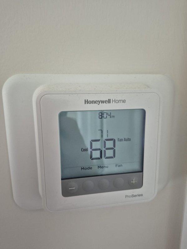 Completed routine cooling maintenance visit on residential HVAC system. Verified thermostat operation showing system cooling properly with setpoint at 71°F and current temperature at 69°F in auto fan mode. Performed electrical diagnostics at air handler using clamp meter, recording amperage draw of 7.94 amps, which falls within normal operating parameters for the unit.