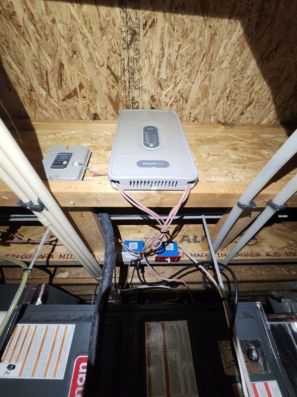 Installed complete Honeywell automatic zone damper system to provide independent temperature control for two zones. System includes HZ432 zone control board, 8-inch automatic bypass damper for system protection, 10-inch round damper for second floor zone, 10x16 damper for first floor zone, and 8x8 damper for additional first floor zone. Configured wireless communication using THM400R1000 wireless adapter paired with ERM5220R1018U remote module for seamless thermostat integration. Installed two TH8321R1000 wireless thermostats to provide individual zone control and programming capability. All ductwork dampers properly mounted in existing trunk lines, wiring completed to zone board, bypass damper installed to prevent static pressure issues, and system tested for proper zone operation and damper response. One-year labor warranty provided on installation.