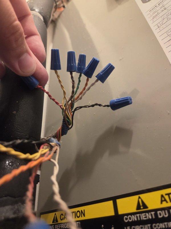 Responded to no heat call on residential HVAC system over 10 years old. Upon arrival, found thermostat set to 69°F with actual room temperature at 74°F. Accessed utility closet housing wall-mounted furnace/air handler unit and performed diagnostic evaluation. Inspected electrical connections and wiring at unit, identifying loose or compromised wire connections secured with wire nuts. Reconnected and properly secured all electrical wiring to ensure safe operation and restore heating functionality. Verified proper electrical continuity throughout system. Cycled unit through heating mode to confirm successful restoration of heat. System operating within normal parameters at time of departure.
