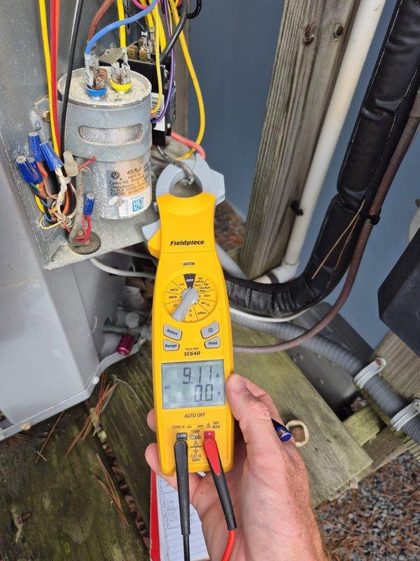 Performed routine cooling maintenance visit on HVAC system. Tested and verified capacitor operation using multimeter, recording voltage readings of 91V and 38V across terminals. Measured system amperage at 27.4 amps with clamp meter to confirm proper compressor draw. Inspected all electrical connections at outdoor condensing unit and indoor air handler, verifying wire terminations and control board connections were secure. All components operating within normal parameters, system cooling effectively.
