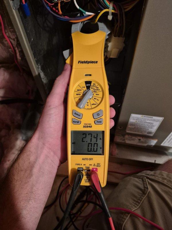 Performed routine cooling maintenance visit on HVAC system. Tested and verified capacitor operation using multimeter, recording voltage readings of 91V and 38V across terminals. Measured system amperage at 27.4 amps with clamp meter to confirm proper compressor draw. Inspected all electrical connections at outdoor condensing unit and indoor air handler, verifying wire terminations and control board connections were secure. All components operating within normal parameters, system cooling effectively.