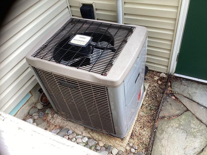 Responded to service call for 18-year-old Custom Comfort HVAC system requiring replacement estimate. Added refrigerant to existing system to maintain temporary operation until replacement can be scheduled. Documented outdoor condenser unit condition and indoor system location with photographs for estimate preparation.