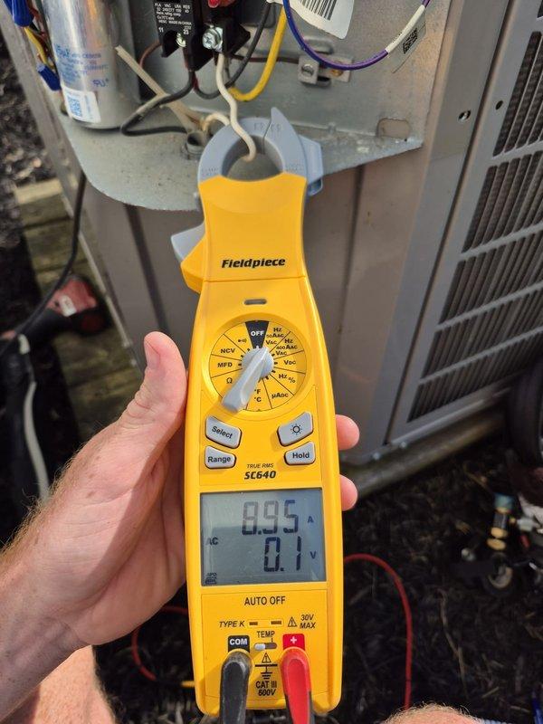 Completed preventative maintenance cooling inspection on residential HVAC system. Verified Honeywell ProSeries thermostat operation showing 73°F set point with system in cooling mode and fan set to auto. Performed electrical diagnostics using clamp meter, measuring current draw at 0.95 amps with system operating within normal parameters. Inspected air handler components, capacitor, and electrical connections, confirming all equipment functioning properly with no issues found.