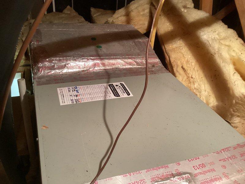 Conducted HVAC system evaluation in residential attic space to provide equipment replacement estimate. Inspected existing air handler unit surrounded by fiberglass insulation and assessed ductwork connections, structural framing, and installation conditions. Documented current equipment specifications and attic access points to develop comprehensive replacement proposal for homeowner consideration.