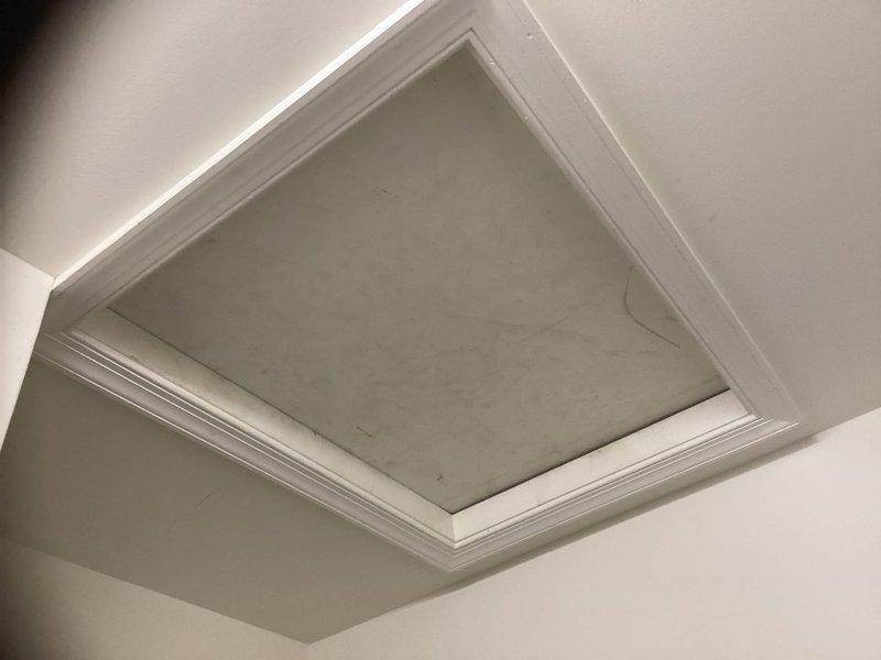 Conducted HVAC system evaluation in residential attic space to provide equipment replacement estimate. Inspected existing air handler unit surrounded by fiberglass insulation and assessed ductwork connections, structural framing, and installation conditions. Documented current equipment specifications and attic access points to develop comprehensive replacement proposal for homeowner consideration.