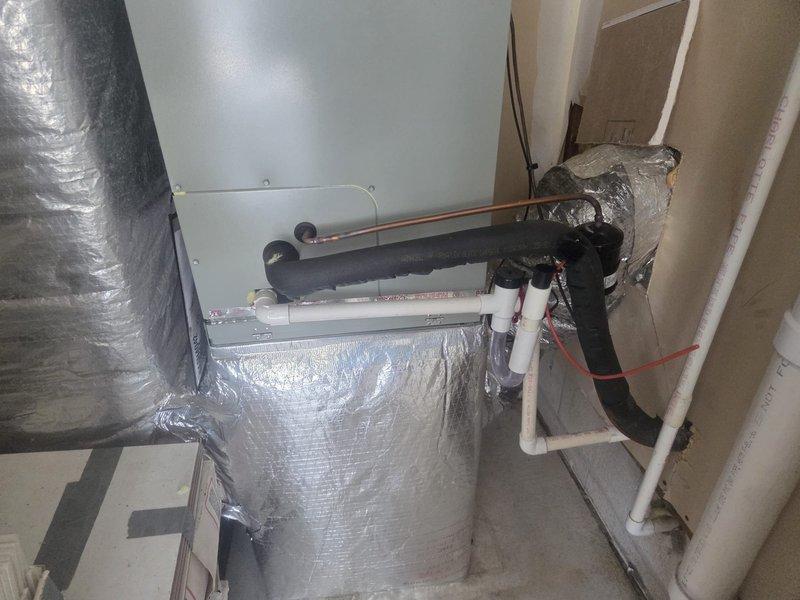 Completed full HVAC system replacement for a two-story residential property with dual independent climate zones. Removed and properly disposed of all existing equipment from both floors. 

**First Floor System:**
Installed 5A7A4030 2.5 ton 14.3 SEER air conditioner with matching 5TXCB04 evaporator coil. Installed S9X1B060U3P gas furnace with LP conversion kit for propane operation. Added 1" filter rack for improved air filtration.

**Second Floor System:**
Installed 5A6H4042 3.5 ton 14.3 SEER heat pump system with 5TEM4B04 standard fan coil unit. Integrated BAYHTR1715BRKR 15KW electric backup heater with dedicated breaker for supplemental heating capacity.

**Outdoor Unit Installation:**
Fabricated and installed pressure-treated wood platform stand for outdoor condenser unit, constructed at elevation meeting local municipal height requirements. Installed electrical whip and disconnect box for code-compliant power connection.

**Refrigeration Work:**
Flushed existing refrigerant lines t