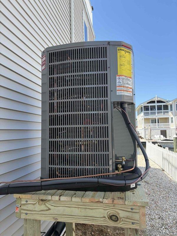 Completed full HVAC system replacement for a two-story residential property with dual independent climate zones. Removed and properly disposed of all existing equipment from both floors. 

**First Floor System:**
Installed 5A7A4030 2.5 ton 14.3 SEER air conditioner with matching 5TXCB04 evaporator coil. Installed S9X1B060U3P gas furnace with LP conversion kit for propane operation. Added 1" filter rack for improved air filtration.

**Second Floor System:**
Installed 5A6H4042 3.5 ton 14.3 SEER heat pump system with 5TEM4B04 standard fan coil unit. Integrated BAYHTR1715BRKR 15KW electric backup heater with dedicated breaker for supplemental heating capacity.

**Outdoor Unit Installation:**
Fabricated and installed pressure-treated wood platform stand for outdoor condenser unit, constructed at elevation meeting local municipal height requirements. Installed electrical whip and disconnect box for code-compliant power connection.

**Refrigeration Work:**
Flushed existing refrigerant lines t