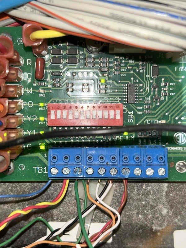 Responded to no cooling call on geothermal heat pump system. Upon arrival, unit was not operational. Verified electrical supply at breaker panel - all breakers in proper position. Inspected Carrier air handler in attic space and control board connections. Diagnosed failed control board preventing unit operation. Replaced defective circuit board and verified all wire terminations at TB1 terminal block secure. Tested system operation - unit now running properly with cooling restored.