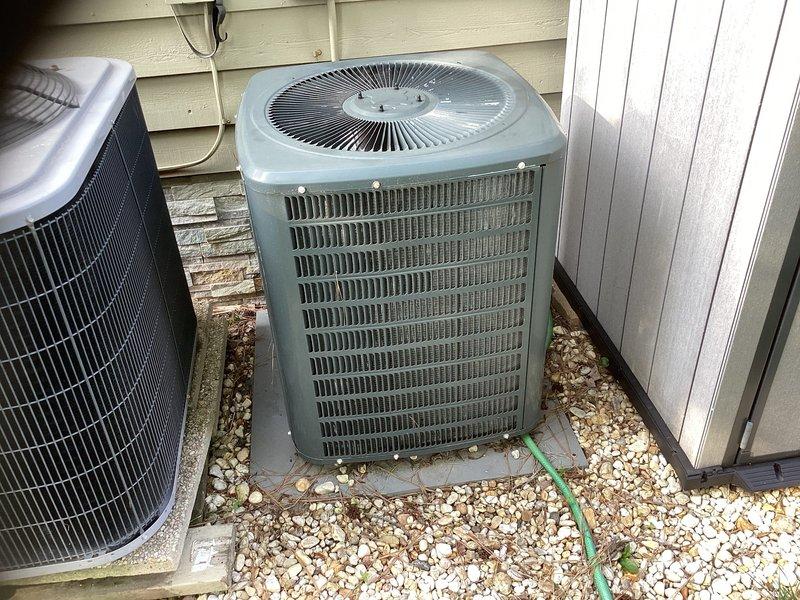Responded to no cooling complaint for upstairs system. Diagnosed R22 system with failed compressor rendering unit inoperable. Provided estimate for complete HVAC system replacement including new outdoor condensing unit, indoor air handler, and electrical disconnect replacement. System located with outdoor unit on ground-level gravel pad against exterior wall and air handler installed horizontally in attic space with flexible duct distribution.