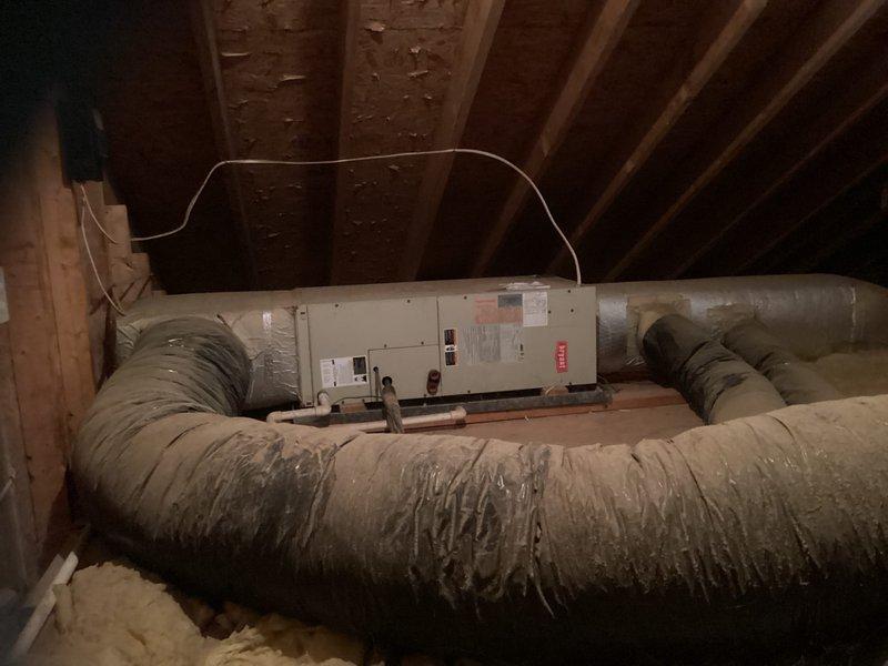 Responded to no cooling complaint for upstairs system. Diagnosed R22 system with failed compressor rendering unit inoperable. Provided estimate for complete HVAC system replacement including new outdoor condensing unit, indoor air handler, and electrical disconnect replacement. System located with outdoor unit on ground-level gravel pad against exterior wall and air handler installed horizontally in attic space with flexible duct distribution.