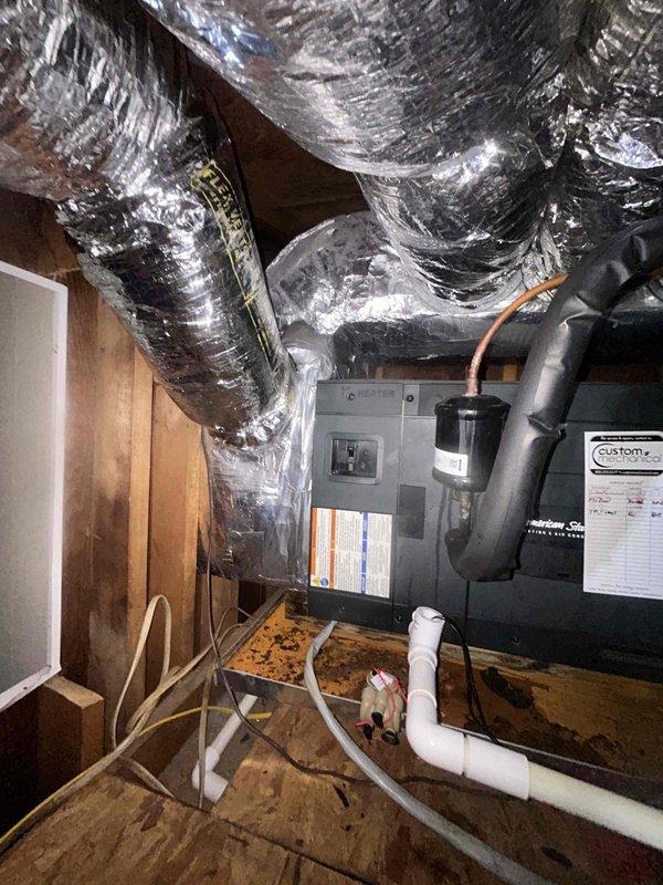 # HVAC Service Call - No Cooling Issue

Responded to service call for system failing to reach set temperature. Upon arrival, accessed attic-mounted air handler unit to diagnose cooling deficiency. Performed visual inspection of equipment and associated components including ductwork, condensate drainage system, and electrical connections. Photographed installation showing air handler unit, flexible duct distribution system, PVC condensate lines, and refrigerant piping. Unit appeared to be properly installed with adequate clearances and standard attic configuration. Documented equipment condition and mechanical space layout for diagnostic purposes and service records.