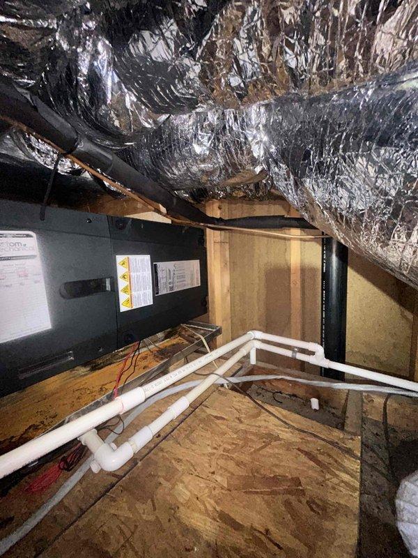 # HVAC Service Call - No Cooling Issue

Responded to service call for system failing to reach set temperature. Upon arrival, accessed attic-mounted air handler unit to diagnose cooling deficiency. Performed visual inspection of equipment and associated components including ductwork, condensate drainage system, and electrical connections. Photographed installation showing air handler unit, flexible duct distribution system, PVC condensate lines, and refrigerant piping. Unit appeared to be properly installed with adequate clearances and standard attic configuration. Documented equipment condition and mechanical space layout for diagnostic purposes and service records.