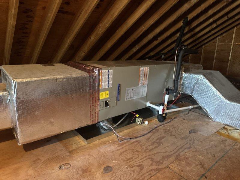Completed full HVAC system replacement including removal and disposal of existing equipment. Installed 2-ton 17 SEER heat pump outdoor unit (5A6H7024) on pressure-treated wood platform with electrical whip and disconnect. Installed variable speed fan coil unit (5TEM6B02) in attic space with drain pan and shut-off valve. Added 10KW electric heat strip with breaker (HTR1510BRKR) for supplemental heating. Installed 1-inch filter rack and WiFi-enabled thermostat (THX1200W) for system control. Flushed existing refrigeration lines, performed pressure test to verify system integrity, and recharged system to manufacturer specifications. Verified proper system operation with manifold gauges showing appropriate pressures and temperatures across both high and low sides. System commissioned and operational for this 2-system home with 1-year contract extension included.