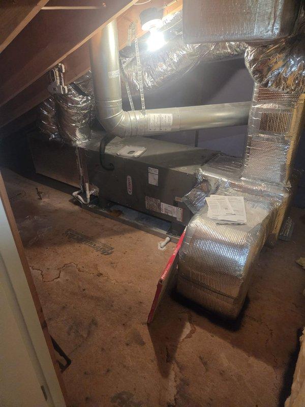 Responded to no cooling complaint on top floor Lennox air handler system in attic space. Previous service visit 1-2 weeks prior reported no issues found, but cooling problem persisted. Upon arrival, inspected attic-mounted horizontal air handler unit and associated ductwork system. Verified unit specifications and reviewed installation. Documented equipment condition and configuration with photos showing air handler, flexible duct connections, and system labels. Investigated potential thermostat or control switch concerns as suggested by occupant to determine root cause of continued cooling failure.
