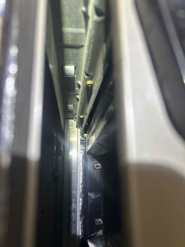 Responded to service call for newly installed heat pump system with water accumulation in return duct. Upon inspection, documented condensate drain pan and drainage system components to verify proper installation and water management. Photographed internal HVAC components including drain pan with visible drain ports, confirming drainage pathways are clear and functional to prevent future water intrusion into ductwork.