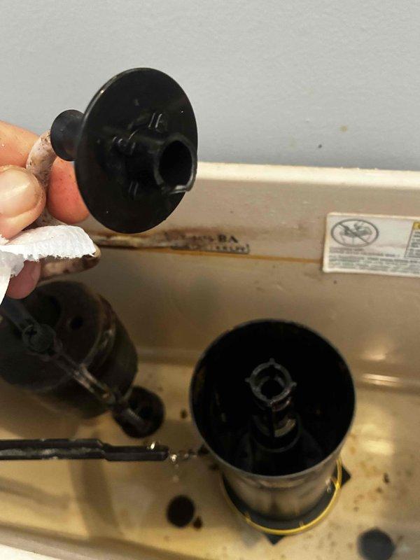 Responded to service call for continuously running toilet and hissing noise from kitchen reverse osmosis system. Inspected toilet tank components and identified faulty fill valve causing constant water flow. Removed and replaced deteriorated fill valve assembly with new unit, including gasket and seals as shown in service photos. Tested flush cycle and verified proper shutoff operation. Examined RO system and determined hissing noise originated from air in lines during tank refill cycle, which is normal operation. Advised homeowner that RO system is functioning correctly and noise indicates tank is filling as designed. Both plumbing issues resolved and systems operating within normal parameters.