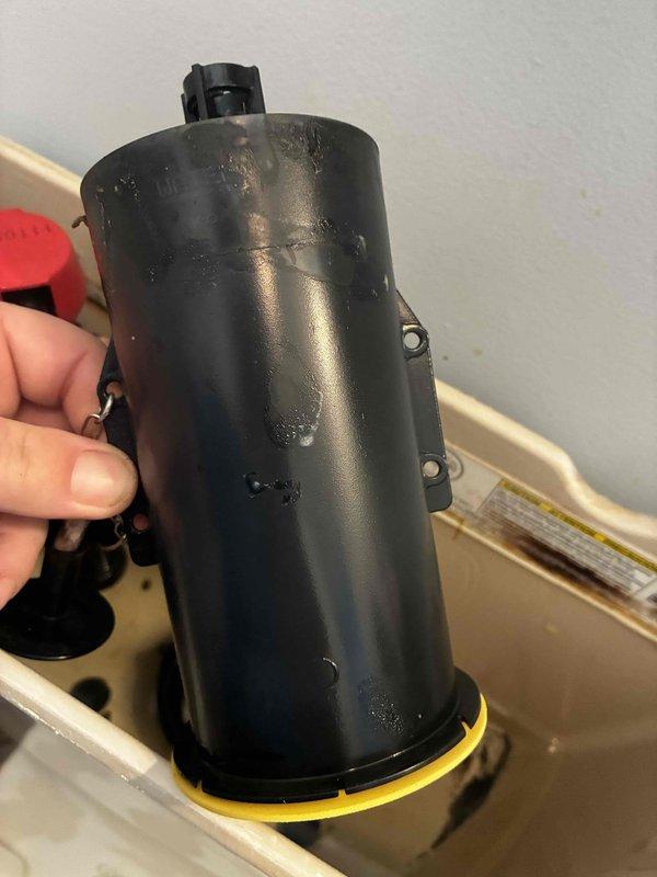 Responded to service call for continuously running toilet and hissing noise from kitchen reverse osmosis system. Inspected toilet tank components and identified faulty fill valve causing constant water flow. Removed and replaced deteriorated fill valve assembly with new unit, including gasket and seals as shown in service photos. Tested flush cycle and verified proper shutoff operation. Examined RO system and determined hissing noise originated from air in lines during tank refill cycle, which is normal operation. Advised homeowner that RO system is functioning correctly and noise indicates tank is filling as designed. Both plumbing issues resolved and systems operating within normal parameters.