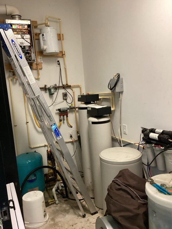 Responded to service call for tankless water heater experiencing intermittent loss of hot water requiring multiple manual resets. Performed complete system flush to remove mineral buildup and scale deposits that were causing the unit to overheat and trigger safety shutoff. Descaled heat exchanger, cleaned inlet filter screen, inspected flow sensor, and verified proper operation of all safety controls. Unit tested successfully with consistent hot water delivery and no fault codes after service completion.
