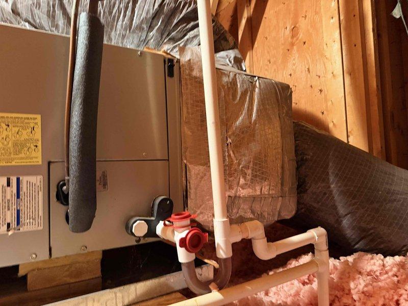 Performed site assessment on 16-year-old HVAC system located in attic space. Identified evaporator coil with active refrigerant leak in nonrepairable location, accompanied by severe rust deterioration. Documented existing equipment condition including air handler unit, flexible ductwork system, and associated components through photographic evidence. Recommended complete system replacement due to age of equipment, extent of coil corrosion, and non-viable repair options.