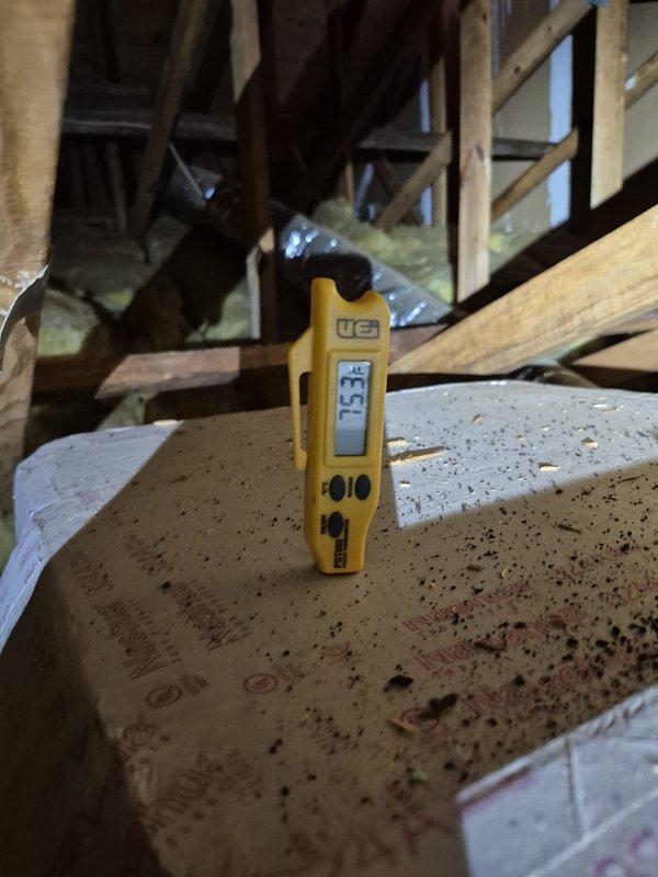 Completed scheduled cooling maintenance visit on residential HVAC system. Accessed attic-mounted equipment and performed temperature diagnostics on supply ductwork, recording 53.6°F at supply plenum and 25.1°F differential measurements to verify proper system operation. Inspected ductwork insulation integrity, confirmed all flexible ducts properly sealed with foil jacketing, and verified adequate fiberglass insulation coverage throughout attic space. System operating within normal parameters with appropriate temperature split across evaporator coil.