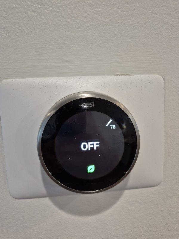 Responded to return service call for no cooling condition on residential HVAC system. Upon arrival, found Nest WiFi thermostat displaying OFF status with ambient temperature reading of 76°F. Inspected attic-mounted air handler unit and associated components including refrigerant lines, condensate drainage system, and ductwork. Verified thermostat communication with system and assessed equipment operation to diagnose cooling issue related to previous service visit. System evaluated and appropriate corrective measures taken to restore normal cooling function.