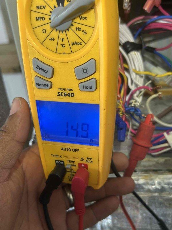 Responded to no cooling complaint and found blank thermostat display. Performed voltage testing at thermostat wiring using digital multimeter, confirmed 24VAC present at R and C terminals measuring 14.8VAC, indicating low voltage power supply issue from transformer or control board. Diagnosed failed thermostat due to lack of proper power or internal component failure preventing display and system operation.