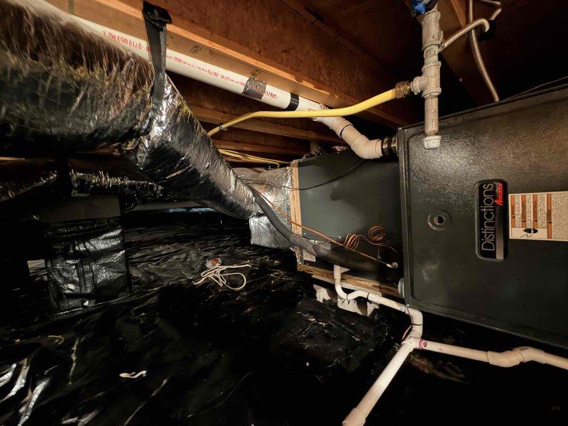 Performed diagnostic evaluation on 16-year-old residential HVAC system with critically low refrigerant charge. System found to be nearly flat, indicating potential coil leak or system failure. Customer declined refrigerant recharge and requested multiple replacement estimates including isolated coil replacement, air conditioning components only (indoor and outdoor coils), and complete system replacement options. Documented existing Daimons furnace installation in attic space with current Honeywell thermostat displaying 87°F, photographed equipment and configuration for estimate preparation.