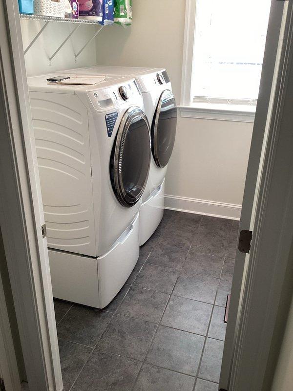 Provided estimate for installation of laundry tub in residential property. Evaluated two potential locations: dedicated laundry room with existing washer/dryer on pedestals and adjacent garage/utility area with tankless water heater. Assessed existing plumbing infrastructure, water supply accessibility, and drainage requirements for both locations to determine optimal placement and installation scope.