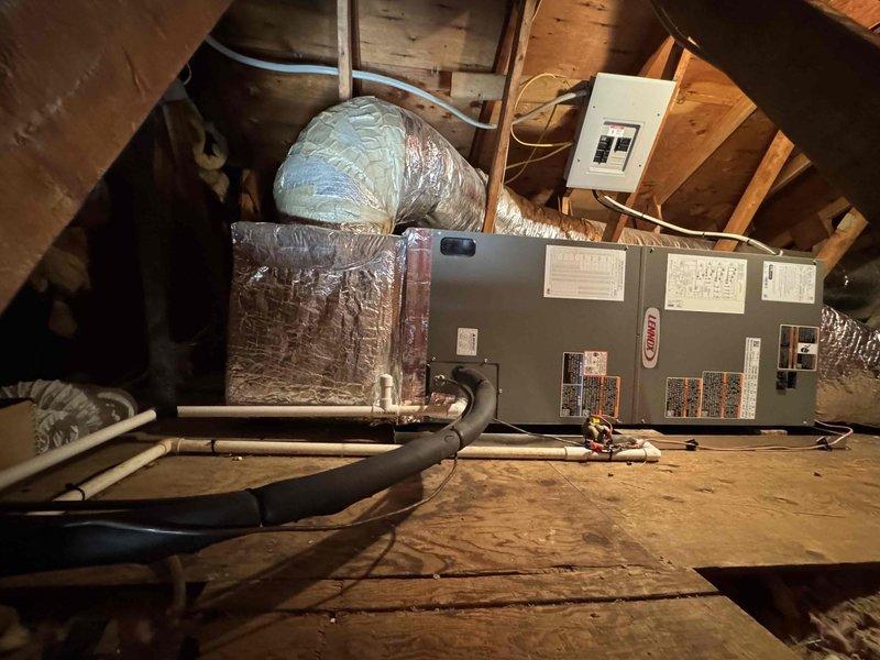 Completed full HVAC system replacement involving removal and disposal of existing equipment. Installed new Lennox ML14KP1-036 3-ton 14 SEER heat pump on pressure-treated wood platform with replacement of outdoor disconnect and electrical whip. In attic space, installed Lennox CBK45UHVT-036 variable speed air handler with 10 kW electric heat pack, fabricated and installed metal duct transitions to adapt to existing ductwork, and reused existing electrical connections, condensation lines, and power lines. Installed 14x24x1 filter grille and Honeywell S1200 digital WiFi thermostat for system control. Extended protection plan coverage one year from previous expiration date. All equipment tested and operational upon completion.