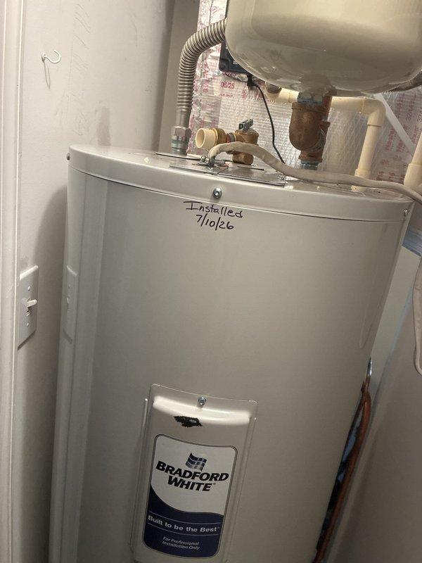 Installed 50-gallon tall Bradford White residential water heater (model RE250T6) in utility closet. Installation included 22-inch drain pan, thermal expansion tank, brass fittings (3/4" x 3" and 3/4" x 6" nipples, 90-degree elbow, tee), dual 18-inch flexible water connectors, and high-temperature rated 3/4" male adapters. Configured all plumbing connections with copper piping, installed temperature and pressure relief valve with discharge tube, and completed all code-compliant safety components. Unit tested and operational upon completion.