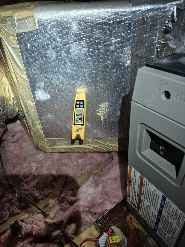 Responded to no cooling complaint in rear section of residence. Upon investigation, confirmed property has two-zone system rather than three separate systems as customer suspected. Measured supply air temperature at 82.5°F in attic air handler serving affected zone, indicating inadequate cooling performance. Inspected air handler and ductwork in attic space, documented insulation conditions and equipment specifications. Clarified system configuration and zoning layout for customer to resolve confusion about HVAC setup.