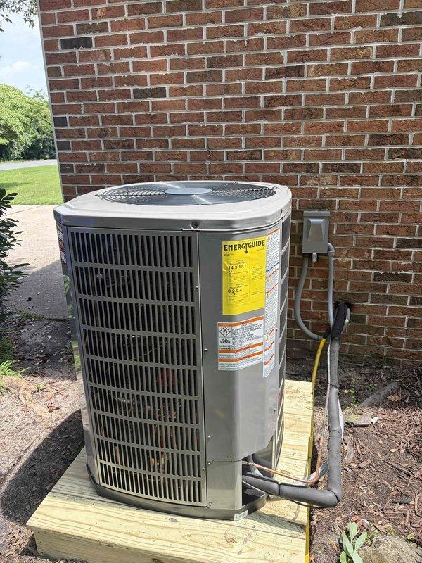Completed full HVAC system replacement including removal and disposal of existing equipment. Installed 3-ton 17 SEER heat pump outdoor unit on wooden platform against brick exterior with proper electrical disconnect and conduit. Indoor installation consisted of variable speed fan coil unit mounted in drain pan with shutoff valve, 15KW electric heat strip with dedicated breaker, 1-inch filter rack, and automatic condensation pump for reliable drainage. Flushed, pressure tested, and recharged refrigeration lines to manufacturer specifications. Installed electrical whip and disconnect for outdoor unit. System completed with WiFi-enabled thermostat for remote temperature control and monitoring. Extended maintenance contract by one year for continued system coverage. All equipment tested and operational upon completion.