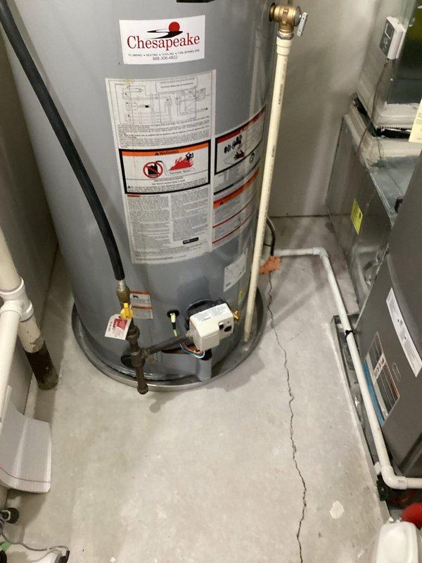 Completed estimate for replacement of existing A.O. Smith ProLine standard water heater with Chesapeake branding. Assessment included evaluation of current installation featuring circulating pump mounted on top unit, copper and PVC supply lines, expansion tank, brass valve connections, and electrical components. Documented existing configuration with multiple pipe connections, safety labels, and mechanical room layout to provide accurate replacement specifications.