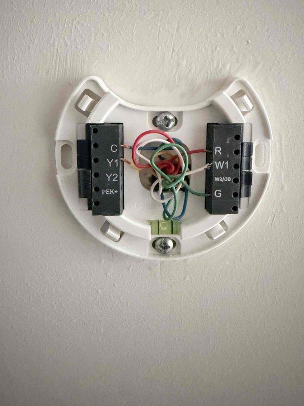 Responded to customer report of upstairs system not cooling properly and producing unusual noise. Upon arrival, inspected the affected HVAC system and thermostat wiring configuration. Documented existing equipment conditions and thermostat setup with detailed photographs. System had been shut down by customer prior to arrival due to concerning operational sounds. Assessed situation and provided estimate for complete system replacement to resolve cooling failure and abnormal operating noise issues.