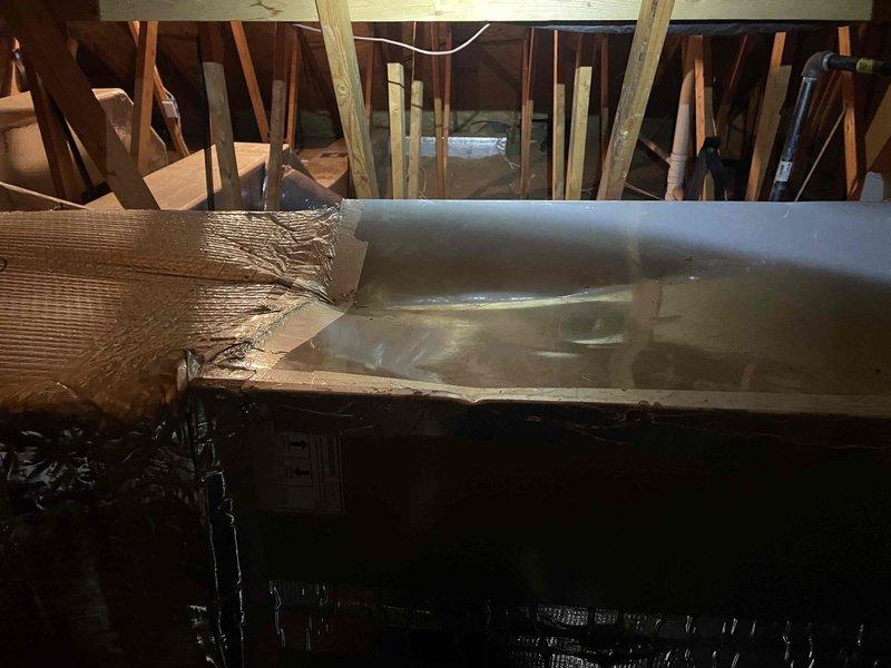 Responded to no cooling call and performed system diagnostics. Inspected attic-mounted air handler and associated ductwork, documenting condensate drain assembly with flexible braided hoses connected to PVC T-joint fitting and noting general system condition. System evaluated and customer advised of findings.