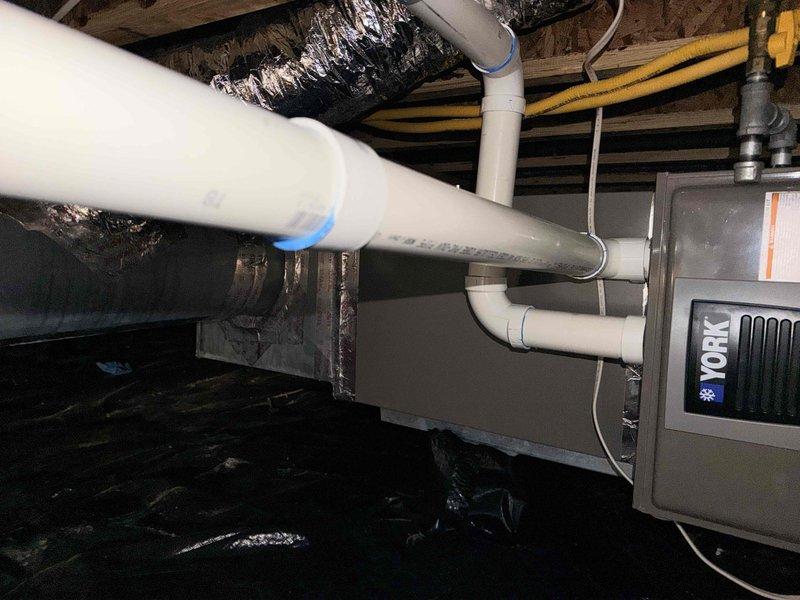 Conducted on-site evaluation of existing 10-year-old HVAC system for replacement estimate. Customer requested heat pump system with furnace backup configuration. Assessed current York air handler installed in crawlspace and exterior York condenser unit on concrete pad, documented existing ductwork, electrical connections, and plumbing infrastructure to determine replacement specifications and requirements.